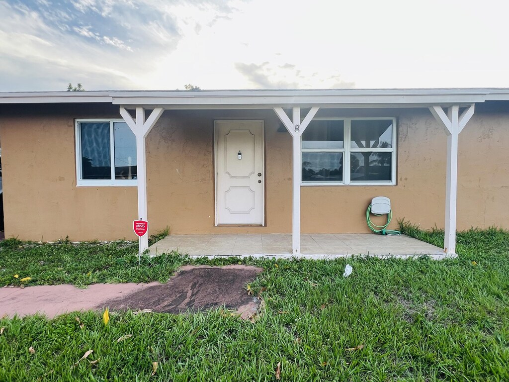 857 Scott Dr, West Palm Beach, FL 33415 - property entrance with stucco siding