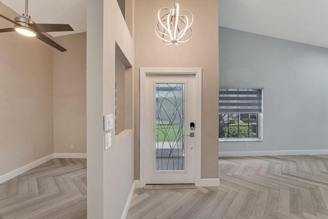 8592 Logia Cir, Boynton Beach, FL 33472 - entrance foyer with a chandelier, baseboards, a ceiling fan, and a high ceiling