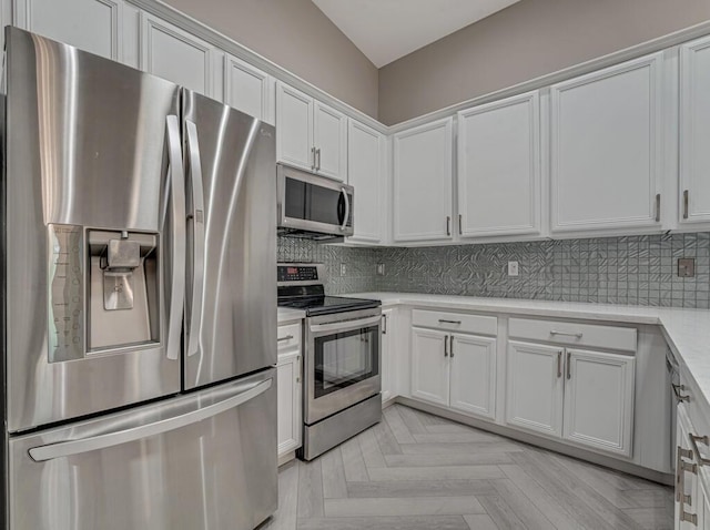 8592 Logia Cir, Boynton Beach, FL 33472 - kitchen featuring appliances with stainless steel finishes, light countertops, tasteful backsplash, and white cabinets