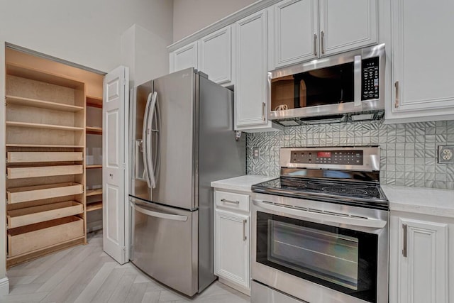 8592 Logia Cir, Boynton Beach, FL 33472 - kitchen featuring stainless steel appliances, decorative backsplash, and white cabinets