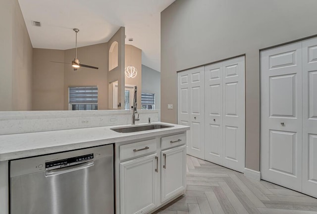8592 Logia Cir, Boynton Beach, FL 33472 - kitchen featuring stainless steel dishwasher, white cabinetry, a sink, high vaulted ceiling, and light stone countertops