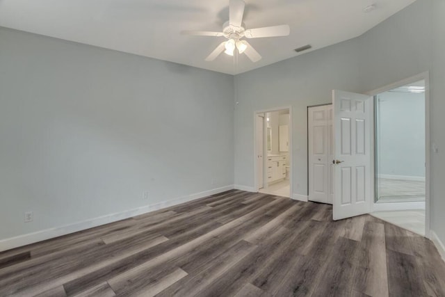 8592 Logia Cir, Boynton Beach, FL 33472 - unfurnished bedroom featuring wood finished floors, baseboards, connected bathroom, and a ceiling fan