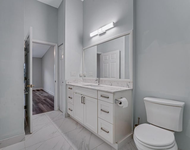 8592 Logia Cir, Boynton Beach, FL 33472 - bathroom with marble finish flooring, vanity, toilet, and baseboards
