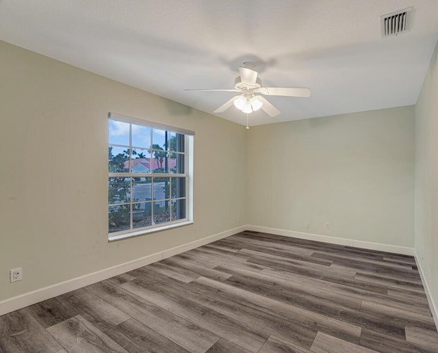 8592 Logia Cir, Boynton Beach, FL 33472 - empty room featuring a ceiling fan, dark wood-type flooring, and baseboards