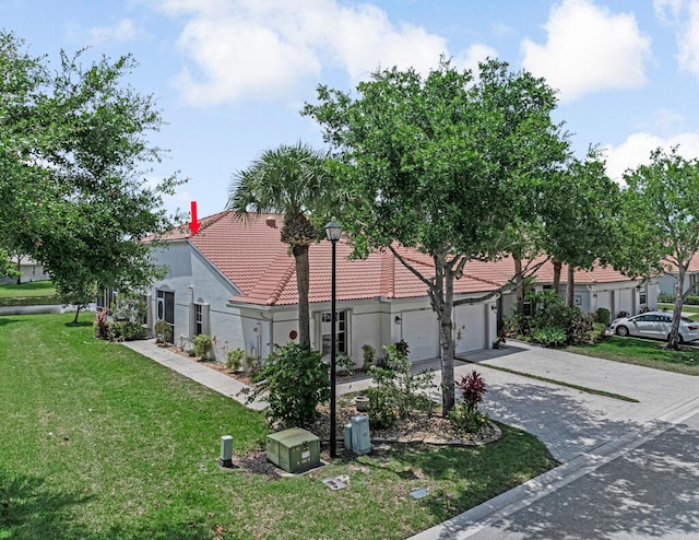 8592 Logia Cir, Boynton Beach, FL 33472 - view of front of property featuring driveway, stucco siding, a tiled roof, a front lawn, and an attached garage