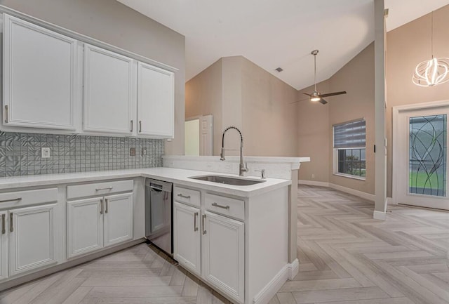 8592 Logia Cir, Boynton Beach, FL 33472 - kitchen with dishwasher, a sink, a peninsula, backsplash, and light countertops