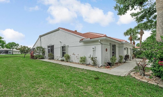 8592 Logia Cir, Boynton Beach, FL 33472 - rear view of house featuring a yard, a tile roof, and stucco siding
