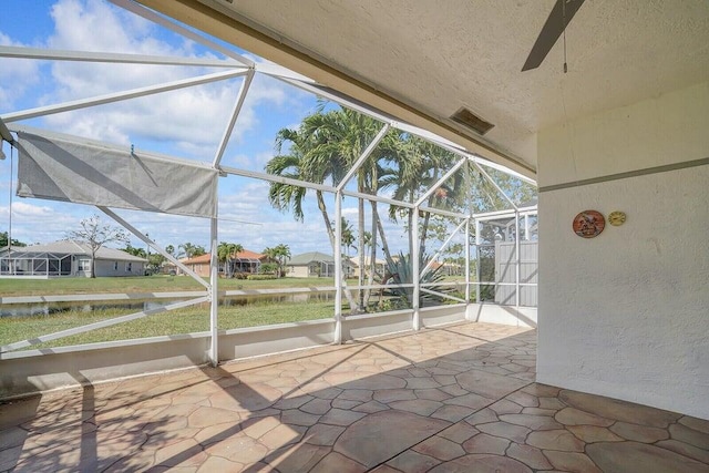 8592 Logia Cir, Boynton Beach, FL 33472 - unfurnished sunroom featuring a ceiling fan, a water view, and a residential view