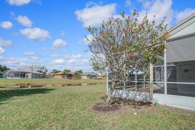 8592 Logia Cir, Boynton Beach, FL 33472 - view of grassy yard featuring a water view, a residential view, and glass enclosure