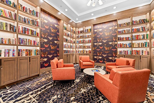 8592 Logia Cir, Boynton Beach, FL 33472 - living area featuring wall of books, recessed lighting, and built in shelves