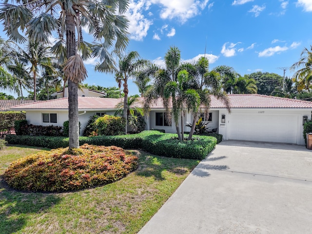 1109 SE 12th Ter, Deerfield Beach, FL 33441 - view of front facade featuring a tile roof, stucco siding, and a garage