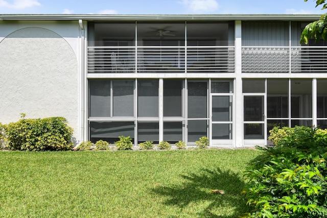 4 Garden St Unit 204N, Tequesta, FL 33469 - back of property featuring stucco siding, a yard, and a sunroom