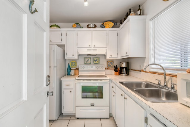 4 Garden St Unit 204N, Tequesta, FL 33469 - kitchen featuring white appliances, under cabinet range hood, a sink, and white cabinets