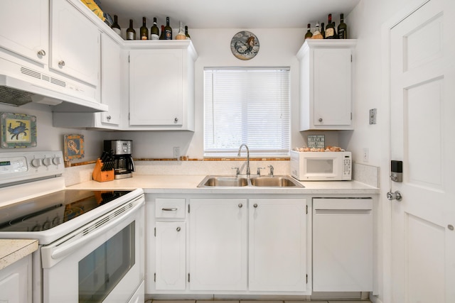 4 Garden St Unit 204N, Tequesta, FL 33469 - kitchen with white appliances, a sink, under cabinet range hood, white cabinets, and light countertops