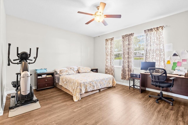 2481 SE Berkshire Blvd, Port Saint Lucie, FL 34952 - bedroom with wood finished floors, a desk, baseboards, and ceiling fan
