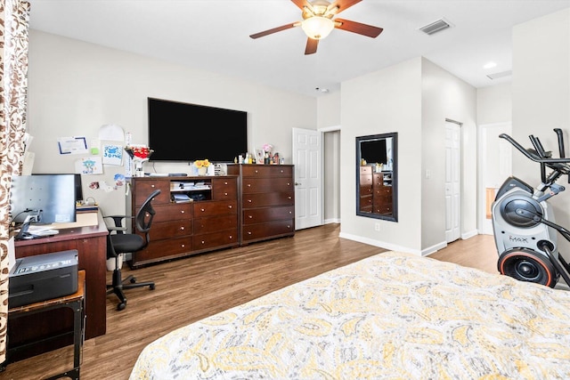 2481 SE Berkshire Blvd, Port Saint Lucie, FL 34952 - bedroom with wood finished floors, an office area, ceiling fan, and baseboards