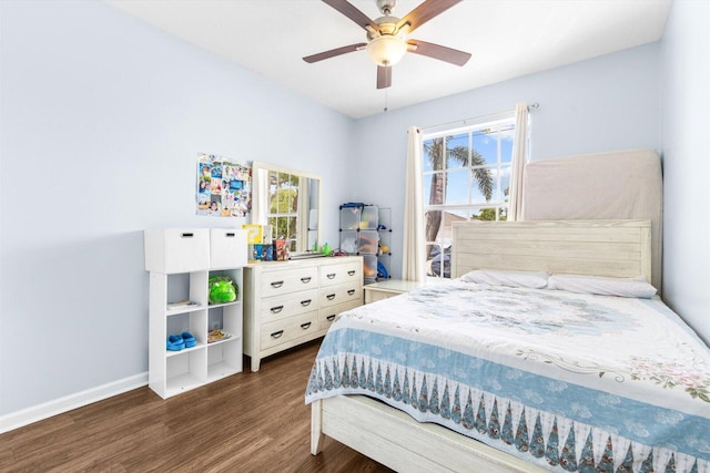 2481 SE Berkshire Blvd, Port Saint Lucie, FL 34952 - bedroom featuring wood finished floors, multiple windows, baseboards, and a ceiling fan