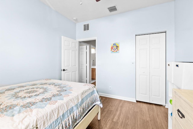 2481 SE Berkshire Blvd, Port Saint Lucie, FL 34952 - bedroom featuring wood finished floors, baseboards, a closet, and ceiling fan