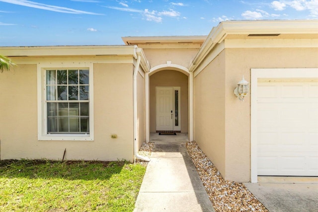 2481 SE Berkshire Blvd, Port Saint Lucie, FL 34952 - property entrance with stucco siding and a garage