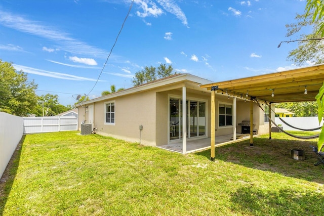 2481 SE Berkshire Blvd, Port Saint Lucie, FL 34952 - rear view of property featuring stucco siding, central AC unit, and a patio area