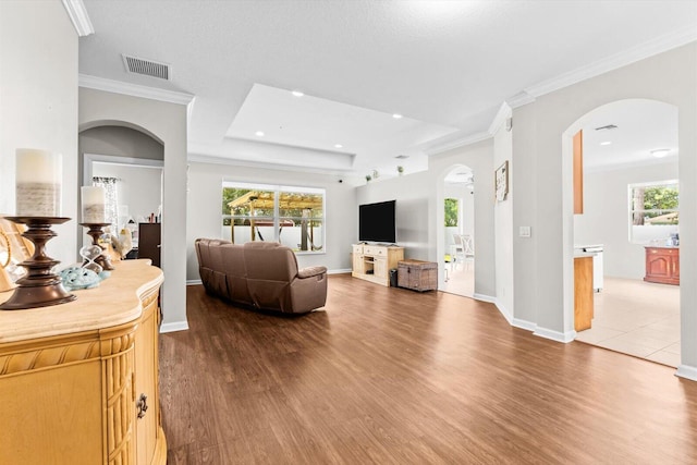 2481 SE Berkshire Blvd, Port Saint Lucie, FL 34952 - living area with arched walkways, dark wood-style floors, crown molding, baseboards, and recessed lighting