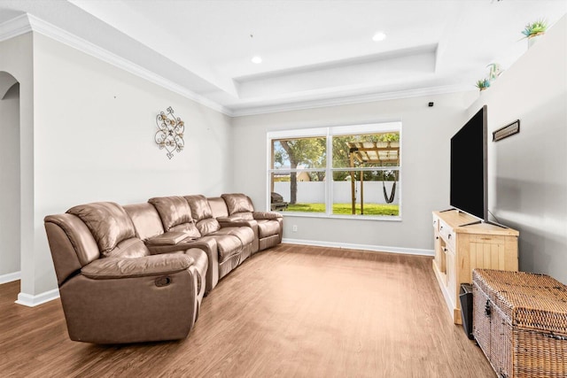 2481 SE Berkshire Blvd, Port Saint Lucie, FL 34952 - living area featuring a tray ceiling, light wood finished floors, arched walkways, baseboards, and recessed lighting