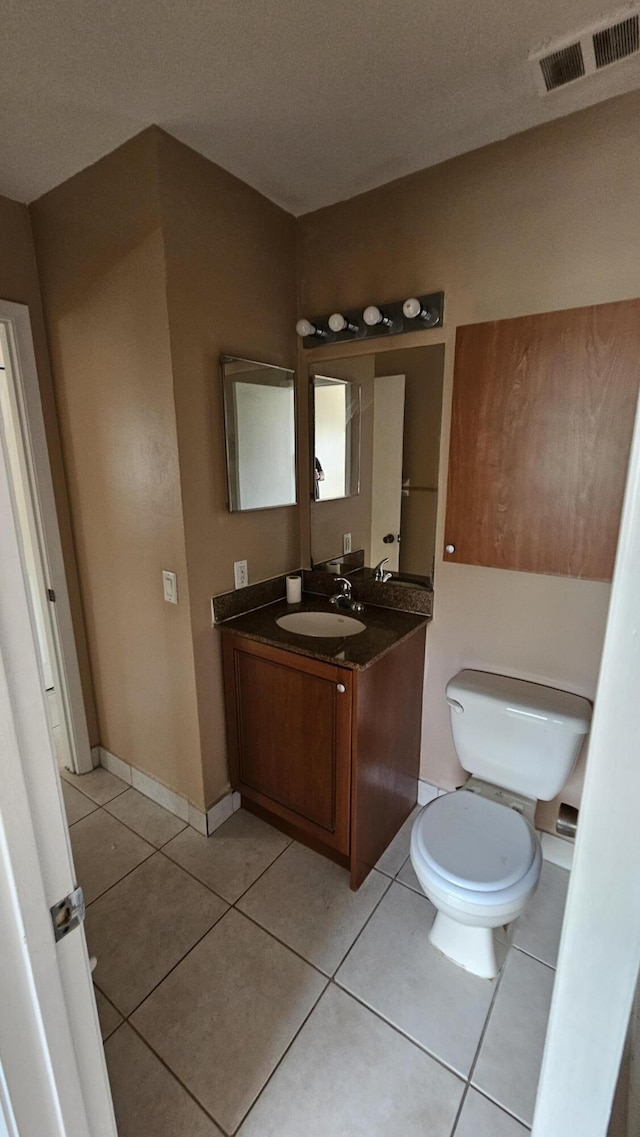 11474 NW 42nd St Unit 11474, Coral Springs, FL 33065 - bathroom featuring toilet, vanity, and tile patterned flooring