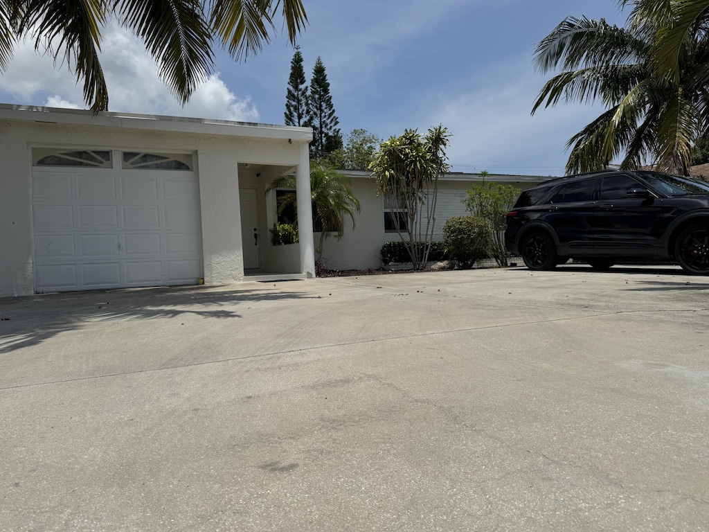 4607 Sutton Ter S, West Palm Beach, FL 33415 - view of front of property featuring stucco siding and driveway