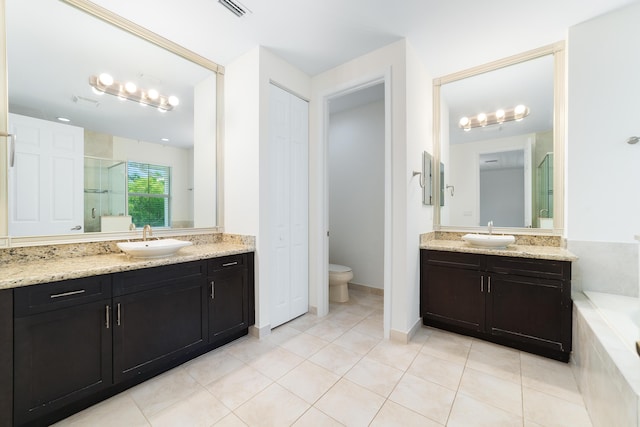 3040 Princeton Ln, Palm Beach Gardens, FL 33418 - full bath with two vanities, a shower stall, tile patterned floors, a garden tub, and toilet