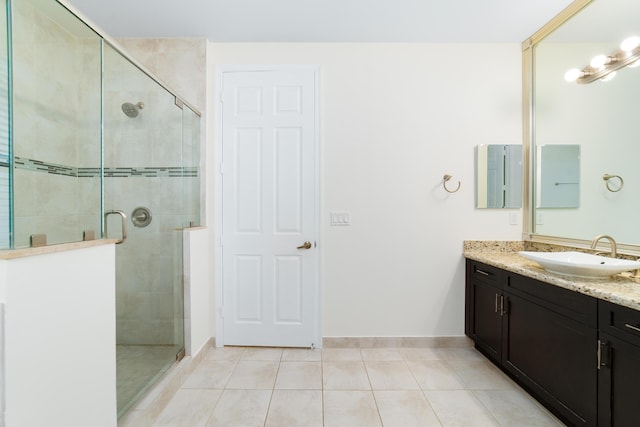 3040 Princeton Ln, Palm Beach Gardens, FL 33418 - full bath featuring vanity, tile patterned flooring, a shower stall, and baseboards