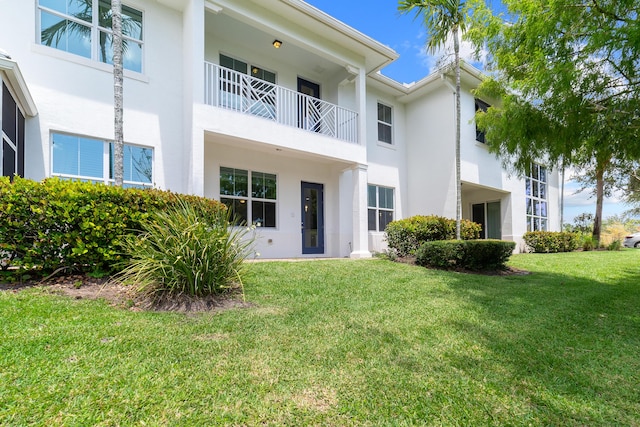 3040 Princeton Ln, Palm Beach Gardens, FL 33418 - back of house with stucco siding and a yard