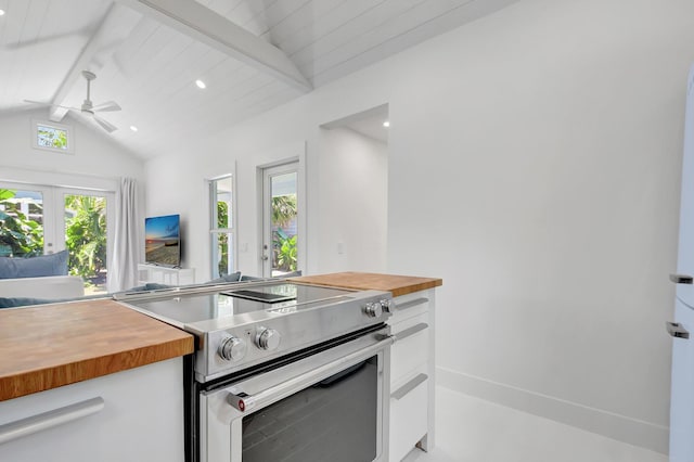 220 S L St, Lake Worth Beach, FL 33460 - kitchen with wood counters, stainless steel electric range oven, white cabinets, a ceiling fan, and open floor plan