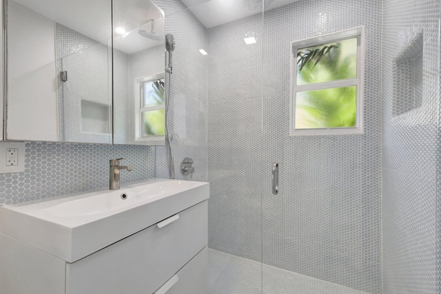 220 S L St, Lake Worth Beach, FL 33460 - full bath featuring vanity, tiled shower, tile walls, and backsplash