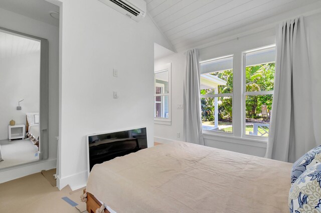 220 S L St, Lake Worth Beach, FL 33460 - bedroom with multiple windows, vaulted ceiling, a wall mounted air conditioner, light colored carpet, and baseboards