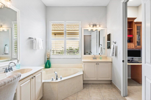 8940 New Hope Ct, West Palm Beach, FL 33411 - bathroom with two vanities, healthy amount of natural light, a garden tub, and tile patterned floors