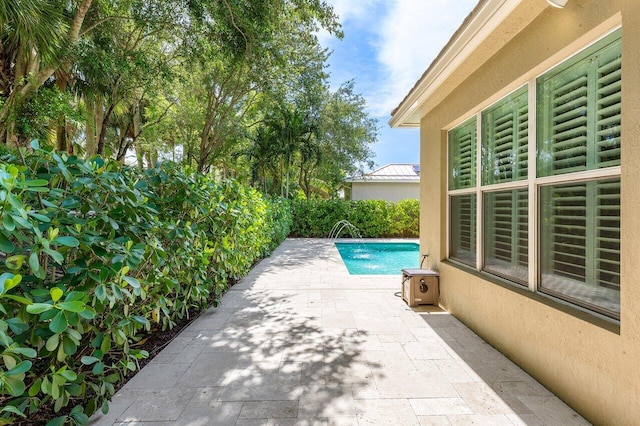 8940 New Hope Ct, West Palm Beach, FL 33411 - view of swimming pool with a patio