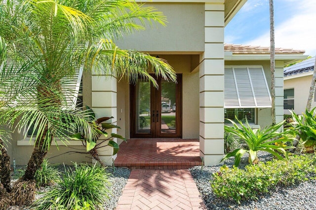 8940 New Hope Ct, West Palm Beach, FL 33411 - property entrance featuring stucco siding and french doors