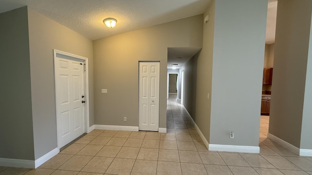 2134 SW Savage Blvd, Port Saint Lucie, FL 34953 - entryway with light tile patterned flooring, a textured ceiling, and baseboards
