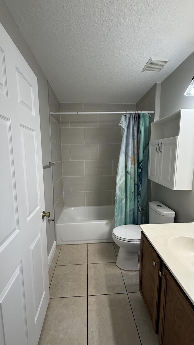 2134 SW Savage Blvd, Port Saint Lucie, FL 34953 - bathroom with toilet, vanity, tile patterned floors, shower / tub combo with curtain, and a textured ceiling