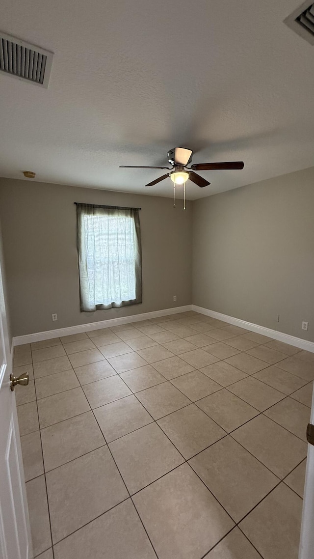 2134 SW Savage Blvd, Port Saint Lucie, FL 34953 - unfurnished room featuring light tile patterned floors, ceiling fan, and baseboards