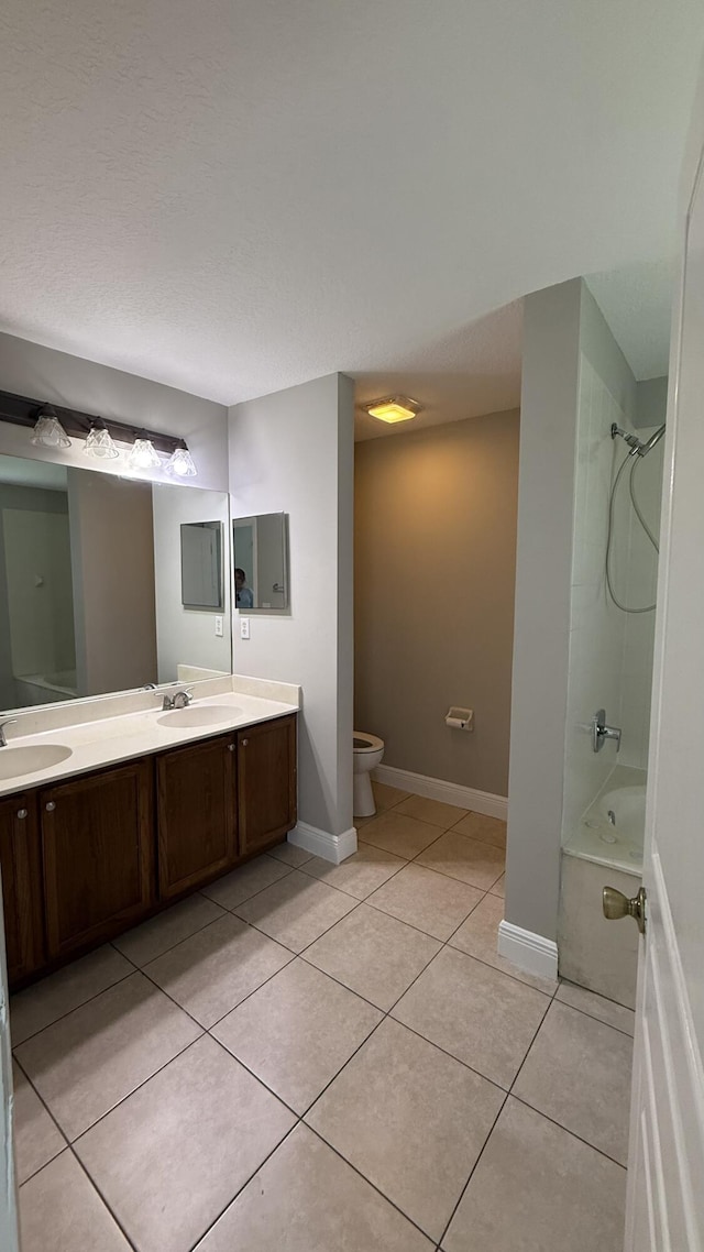 2134 SW Savage Blvd, Port Saint Lucie, FL 34953 - bathroom with double vanity, tile patterned flooring, toilet,  shower combination, and baseboards