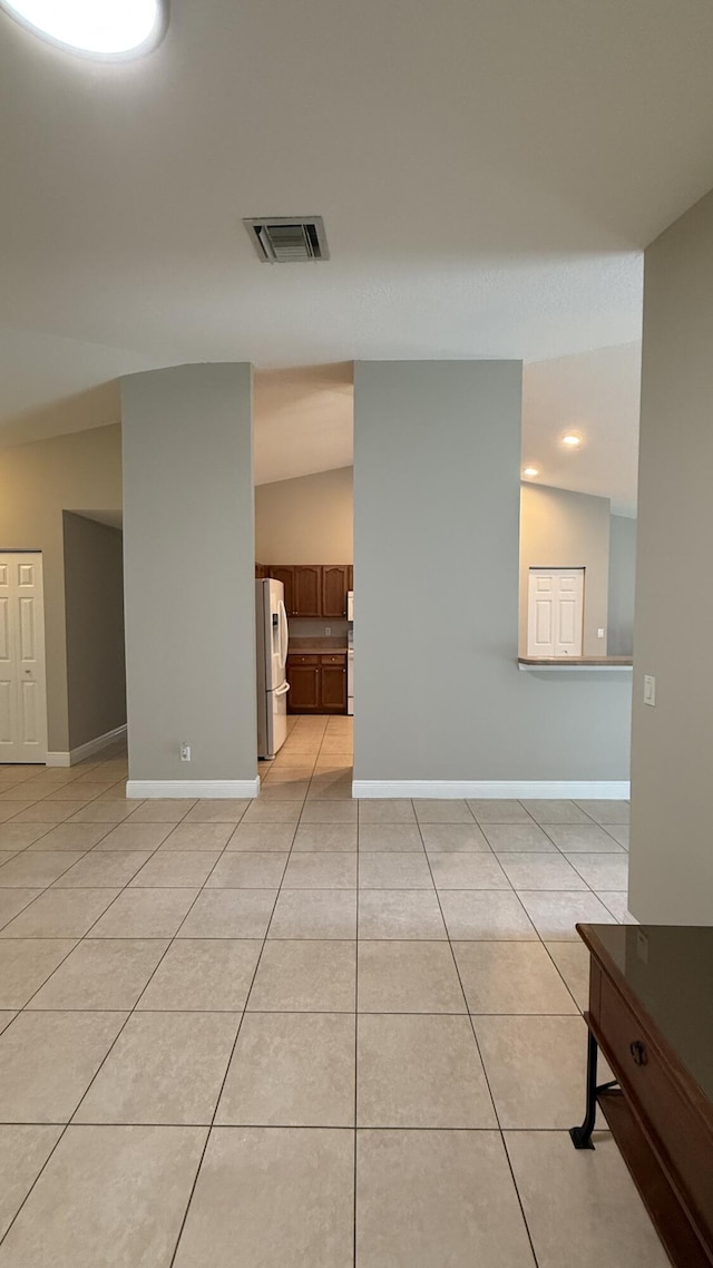 2134 SW Savage Blvd, Port Saint Lucie, FL 34953 - spare room featuring light tile patterned floors, baseboards, vaulted ceiling, and recessed lighting