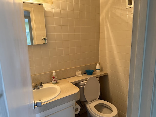 37 Waltham Unit B, West Palm Beach, FL 33417 - half bathroom with tile walls, vanity, decorative backsplash, and toilet