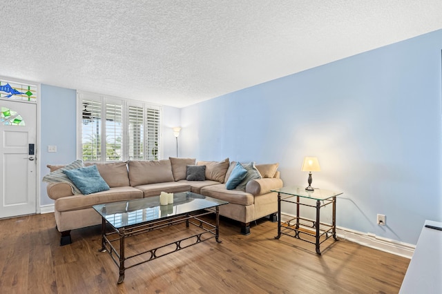 109 Paradise Harbour Blvd Unit 202, North Palm Beach, FL 33408 - living room featuring a textured ceiling, baseboards, and wood finished floors
