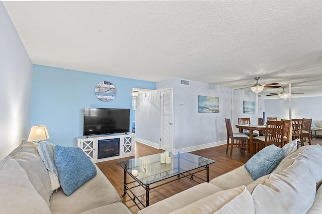 109 Paradise Harbour Blvd Unit 202, North Palm Beach, FL 33408 - living room with a ceiling fan, wood finished floors, and baseboards