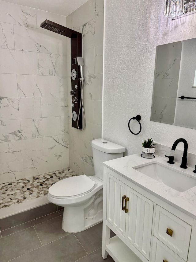 2812 F Rd, Loxahatchee Groves, FL 33470 - full bathroom featuring vanity, toilet, a shower stall, a textured wall, and tile patterned floors