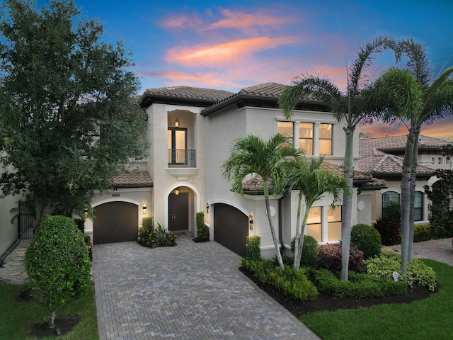 8784 Lewis River Rd, Delray Beach, FL 33446 - mediterranean / spanish house with a balcony, a tiled roof, decorative driveway, a garage, and stucco siding