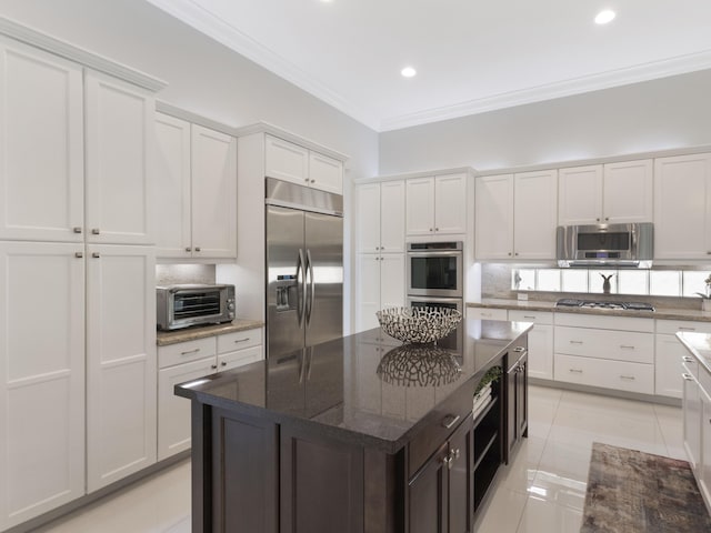 8784 Lewis River Rd, Delray Beach, FL 33446 - kitchen with appliances with stainless steel finishes, ornamental molding, tasteful backsplash, white cabinets, and dark stone counters
