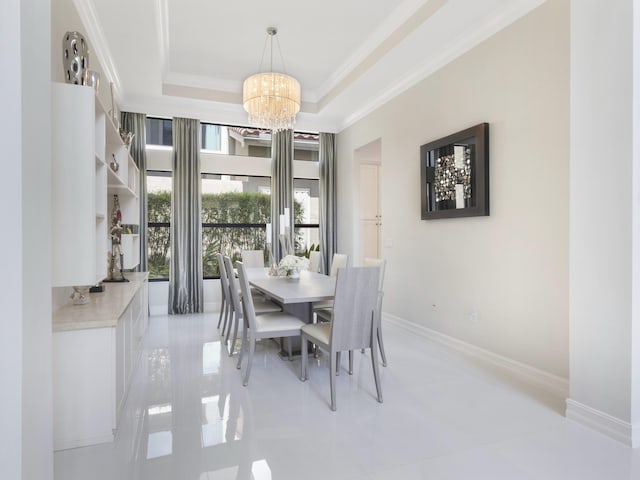 8784 Lewis River Rd, Delray Beach, FL 33446 - dining area with a chandelier, a tray ceiling, ornamental molding, light tile patterned flooring, and baseboards