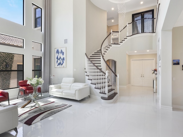 8784 Lewis River Rd, Delray Beach, FL 33446 - tiled entrance foyer with stairway, a towering ceiling, baseboards, recessed lighting, and arched walkways